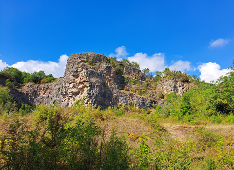 Shot of the cliffs at Llanymyneck Rocks Nature Reserve, with a blue sky