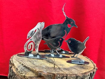 Close up of metal ornaments in shape of birds, lapwing and hare